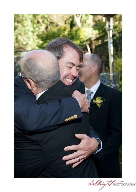 Guest hugging groom at GLBT Wedding in San Francisco