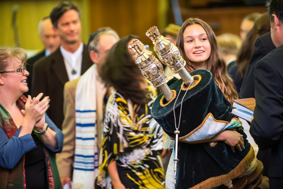 Zoe, the Bat Mitzvah, carries the torah around the synagogue at Or Shalom in San Francisco, CA