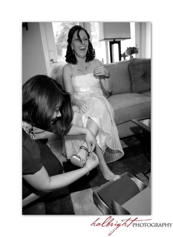 Jill Chatanow is getting helping putting on her weddings shoes from her friend.