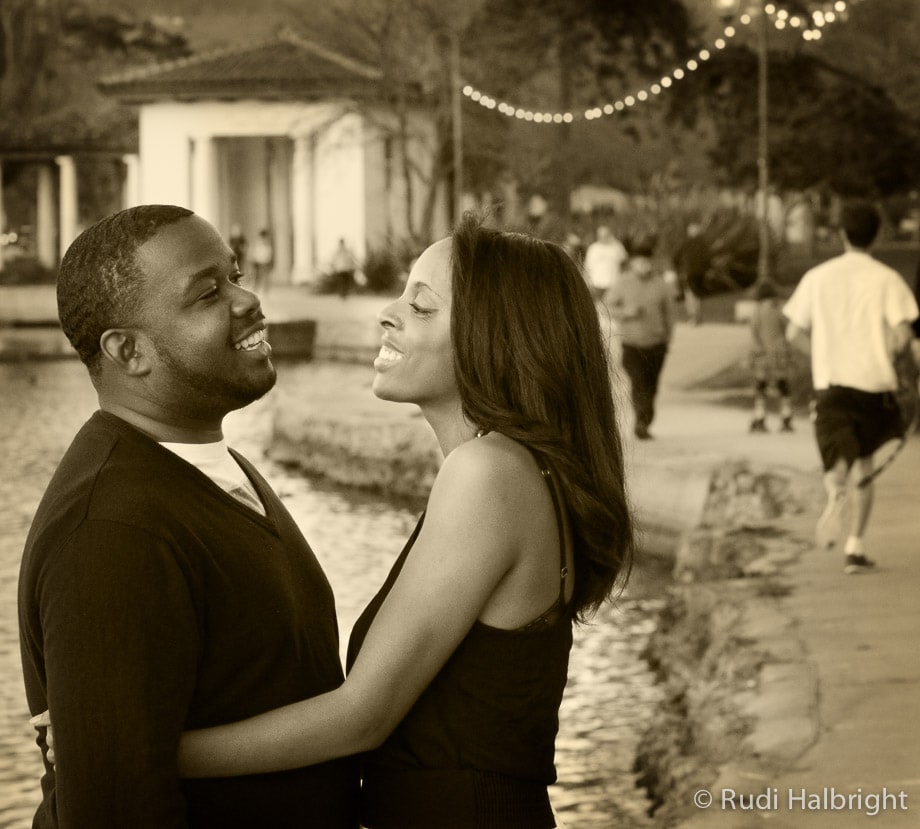 Black couple smiling and facing each other in Lake Merritt in Oakland California portrayed in Sepia tone | Oakland Engagement Portrait - Lake Merritt