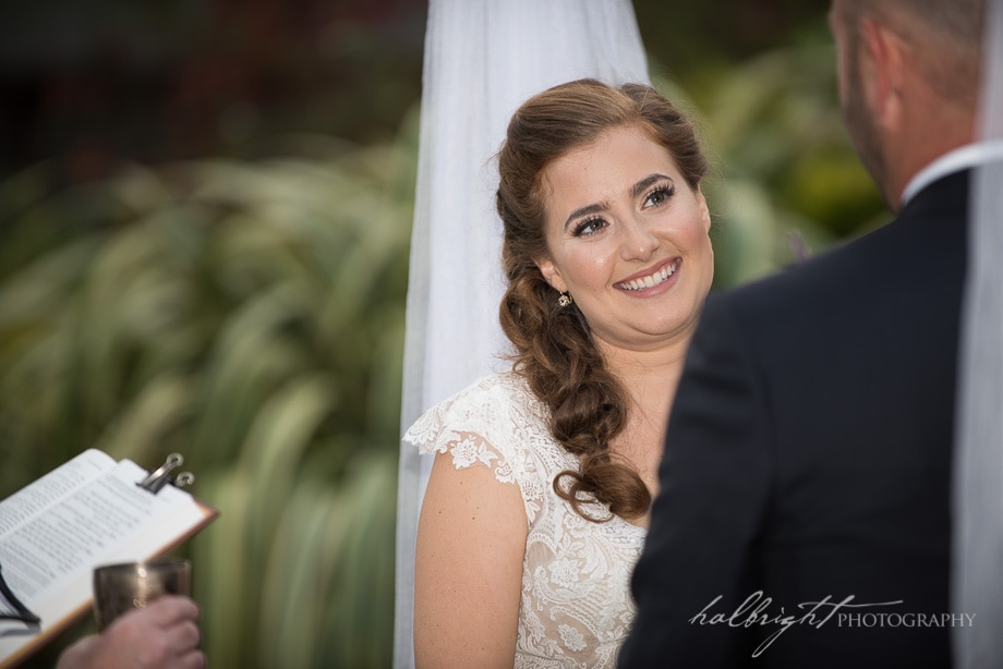 bride gazes as groom under chuppah in tilden park berkeley | Brazil Room Wedding - Tilden Park Berkleey