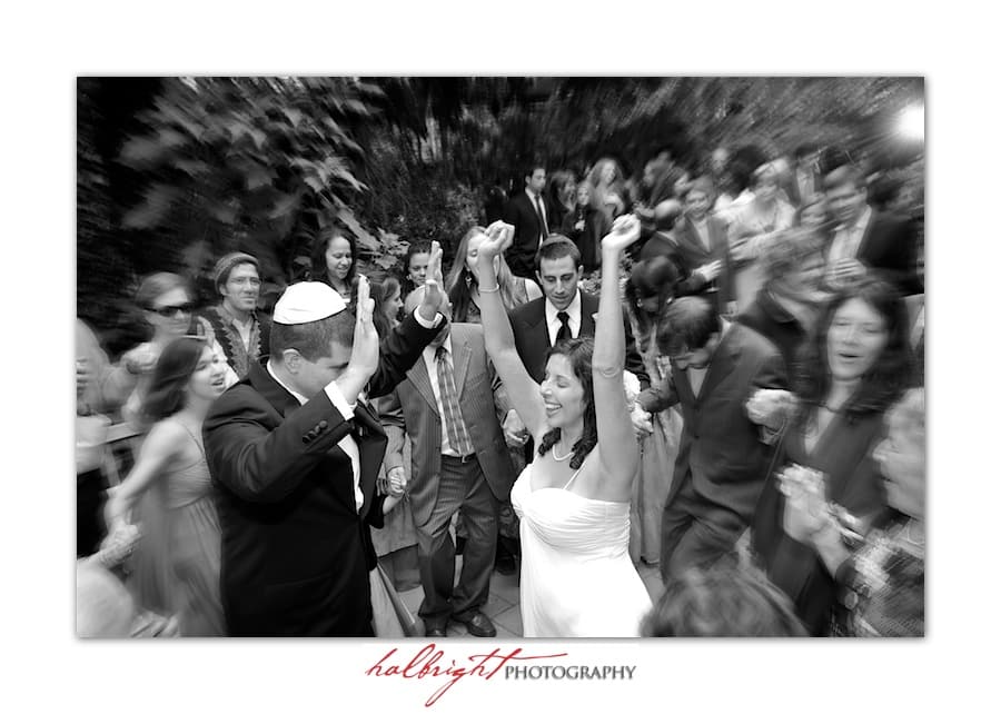 Bride raises her arms in excitement during the first dance - Bodega Bay Secret Gardens - Marin Wedding
