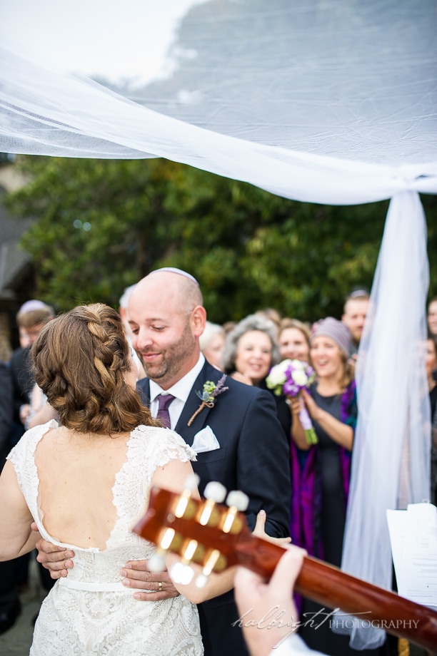 bride and groom kiss under the chuppah - brazil room wedding - tilden park berkeley